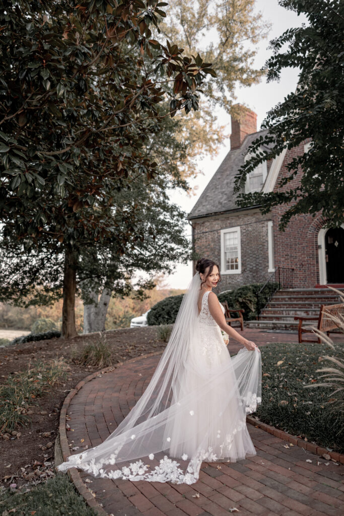 Bride waving veil in the wind.