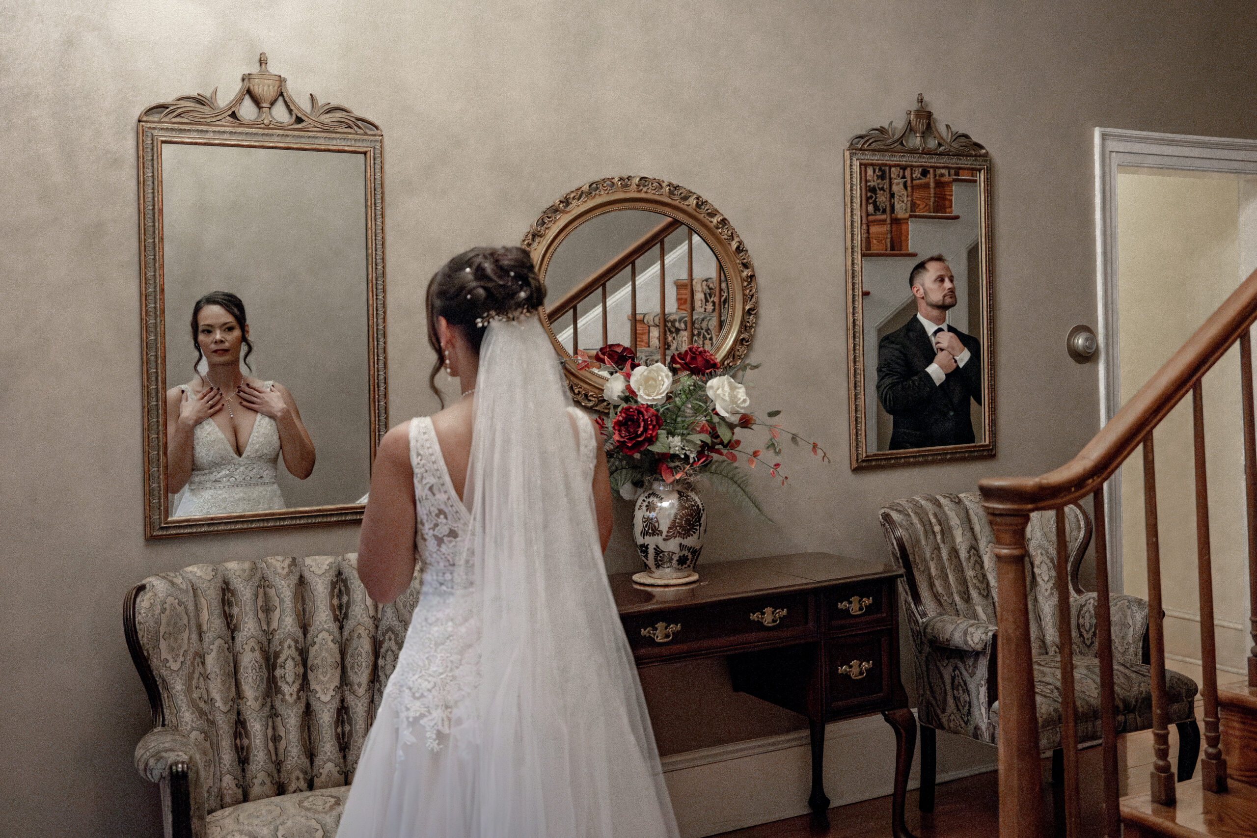 Bride and groom in the reflection of mirror with their back facing the camera