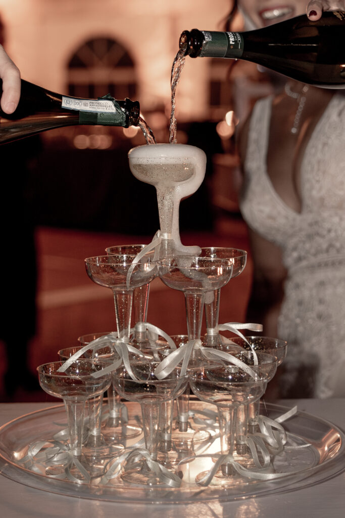 Champagne tower with champagne overflowing.