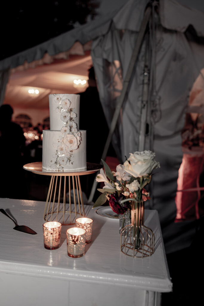 Two layered white cake with florals and gold foiling by KNE Bakery