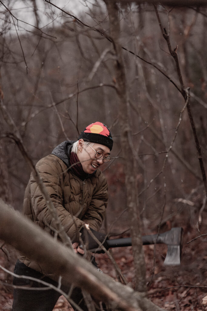 Man chopping wood in forest.